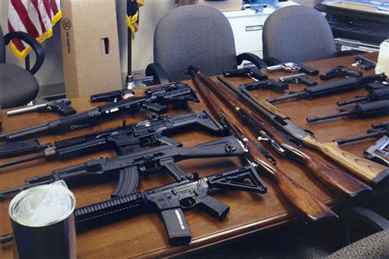 This undated handout photo provided by the Prince George's, Md. County Police shows weapons found in the possession of a suspect who they say was plotting a shooting in his workplace. Police in Maryland say a man who called himself "a joker" and threatened to shoot up his workplace was in the process of being fired. Police say the 28-year-old man was taken into custody Friday morning. Investigators said he was wearing a T-shirt that said "Guns don't kill people. I do." He was taken into custody for an emergency mental health evaluation and charges are pending. (AP Photo/Prince George's County Police)
