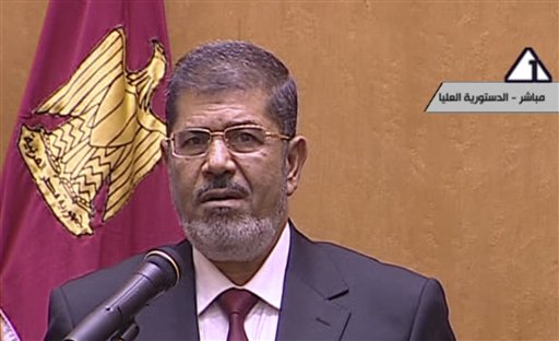 In this image made from Egyptian state television, President Mohammed Morsi vows to rebuild Egypt after being sworn in Saturday.