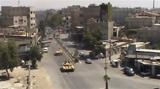 This image made from video provided by Shaam News Network on Tuesday purports to show Syrian tanks in Damascus.