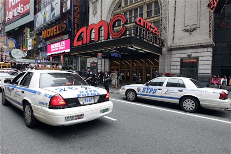Police officers are seen outside a movie theater screening "The Dark Knight Rises," Friday, July 20, 2012 in New York. A gunman in a gas mask barged into a crowded Denver-area theater during a midnight premiere of the Batman movie on Friday, hurled a gas canister and then opened fire, killing 12 people and injuring at least 50 others in one of the deadliest mass shootings in recent U.S. history. NYPD commissioner Ray Kelly said the department was providing the extra security at theaters "as a precaution against copycats and to raise the comfort levels among movie patrons." (AP Photo/Mary Altaffer)