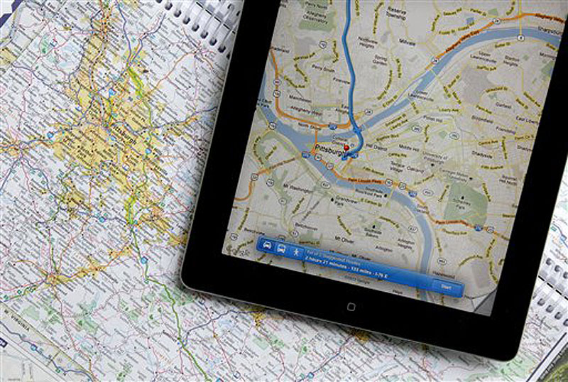 In this Tuesday, May 8, 2012 photo a traditional road map of the Pittsburgh area and one showing the same region on an iPad are seen placed together in Moreland Hills, Ohio. Transportation agencies around the country are printing fewer maps to cut costs or just to acknowledge that public demand is down. (AP Photo/Amy Sancetta)