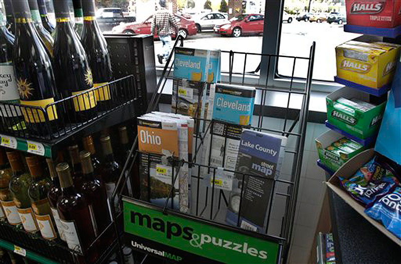 In this Monday, April 9, 2012 photo a scant rack of road maps is seen at a gas station/mini mart in Solon, Ohio on. Colorful maps bearing the logos of the oil companies that printed them _ names like Texaco, Gulf, Esso _ once brimmed from displays at filling stations, free for the taking. (AP Photo/Amy Sancetta)