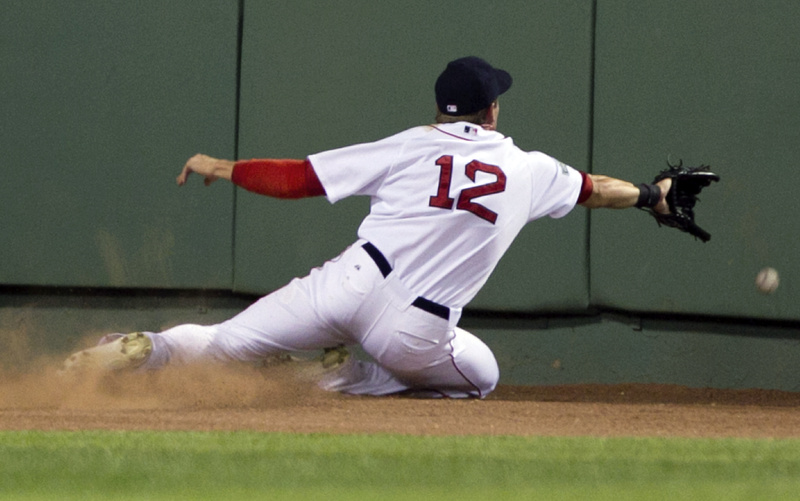 Ryan Sweeney slides toward the wall as he is unable to grab an RBI triple by New York’s Alex Rodriguez in the fifth inning Sunday night at Fenway Park. The Yankees won, 7-3.