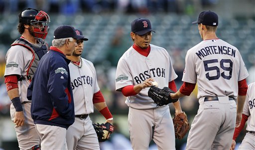 Boston's Daisuke Matsuzaka, center, gives the ball to pitcher Clayton Mortensen after being removed from Monday's match against the Oakland A's in San Francisco.