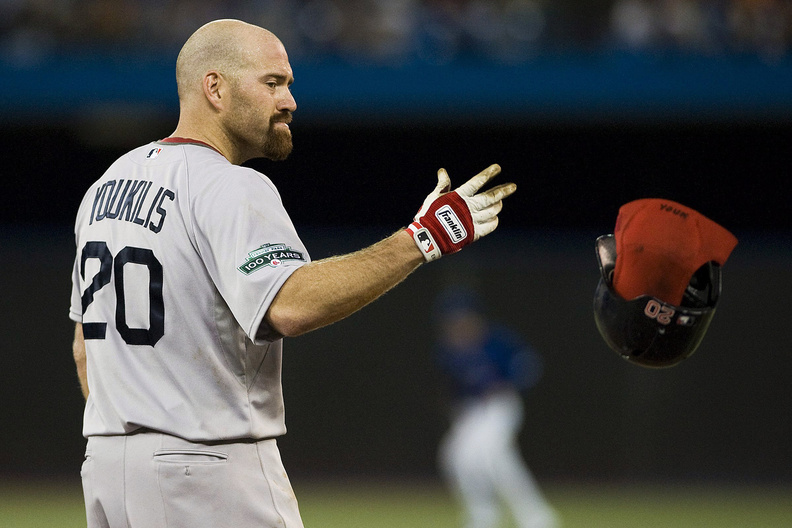 Then-Red Sox third baseman Kevin Youkilis tosses his helmet after grounding out in a game against the Toronto Blue Jays in early June.