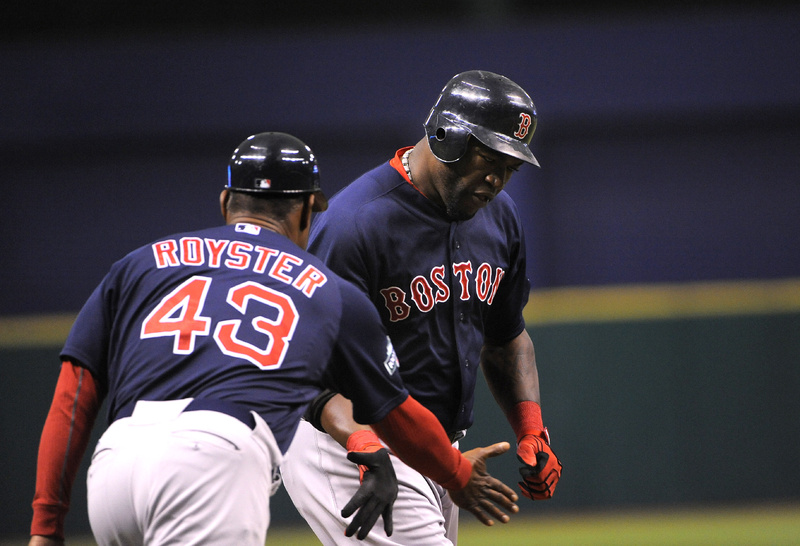 David Ortiz slaps hands with third base coach Jerry Royster as he rounds the bases after hitting a solo home run in the first inning against the Tampa Bay Rays Friday night in St. Petersburg, Fla.