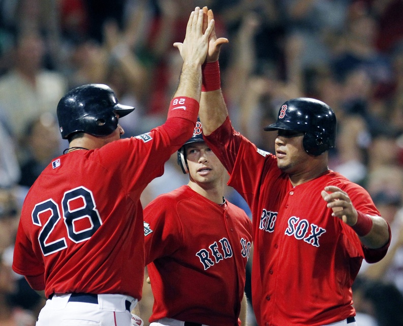Adrian Gonzalez, Daniel Nava, center, and Mauro Gomez, right, celebrate after Gonzalez and Gomez scored on a three-run double by Pedro Ciriaco that also drove in Cody Ross in the sixth inning of game two against the New York Yankees in Boston on Saturday.