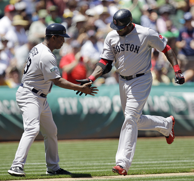 David Ortiz is congratulated by third base coach Jerry Royster after hitting his 400th career home run off Athletics' A.J. Griffin on Wednesday in Oakland.
