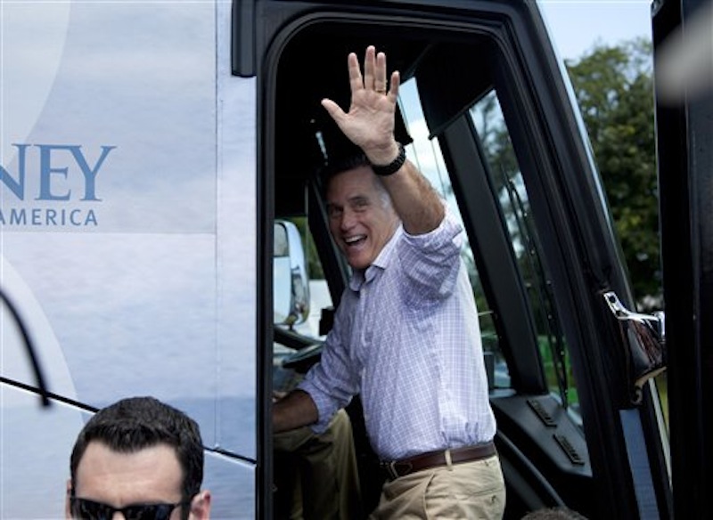 Republican presidential candidate Mitt Romney waves as he gets on his bus after a campaign stop at the Scamman Farm in Stratham, N.H., recently.