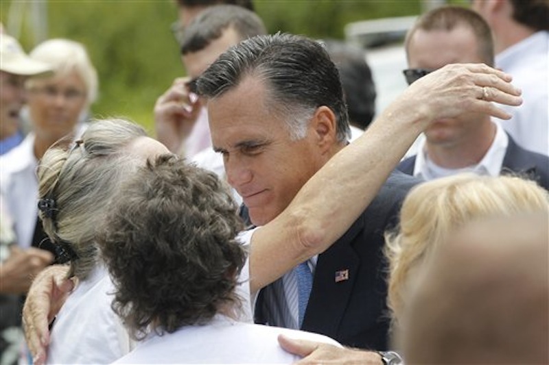 Republican presidential candidate, former Massachusetts Gov. Mitt Romney hugs supporters after he spoke about the shootings in Colorado at an event in Bow, N.H., Friday, July 20, 2012. (AP Photo/Charles Dharapak)