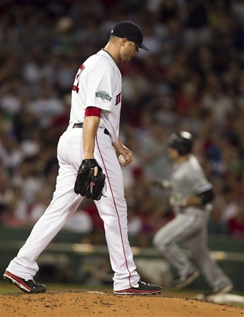 Boston Red Sox's Jon Lester steps on the mound as Chicago White Sox's Kevin Youkilis, right, advances toward home after hitting a three-run home run off a pitch by Lester in the fourth inning of a baseball game in Boston, Tuesday, July 17, 2012. (AP Photo/Steven Senne)