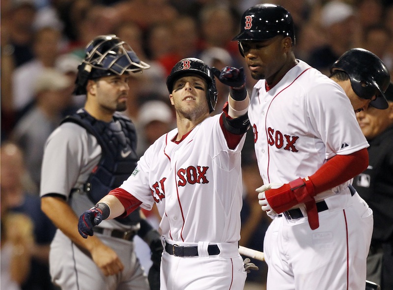 Boston Red Sox's Dustin Pedroia, center, celebrates his two-run home run that drove in Carl Crawford, right, as Detroit Tigers' Alex Avila, left, looks to the mound in the sixth inning of a baseball game in Boston, Monday, July 30, 2012. (AP Photo/Michael Dwyer)