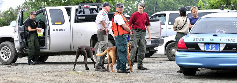 Members of Maine Search and Rescue Dogs assemble at the Pan Am railroad yard in Waterville after searching the area and riverbank for evidence of missing toddler Ayla Reynolds on Tuesday.