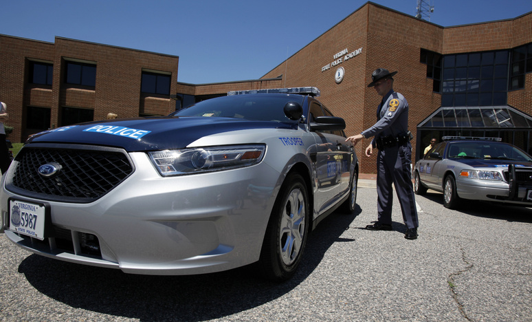 An officer in Virginia checks out a new Ford Taurus police cruiser like the ones that will be used by Maine State Police.