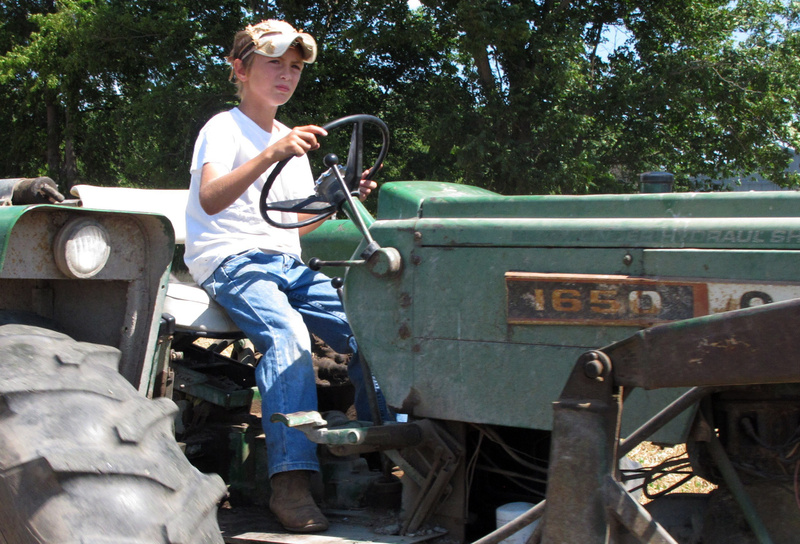 Ten-year-old Jacob Mosbacher guides a tractor through a bean field on his grandparents' property near Fults, Ill. Officials in the U.S. Department of Labor recently proposed a rule limiting what kinds of jobs teenagers could hold in agricultural industries, including close relatives’ family farms.