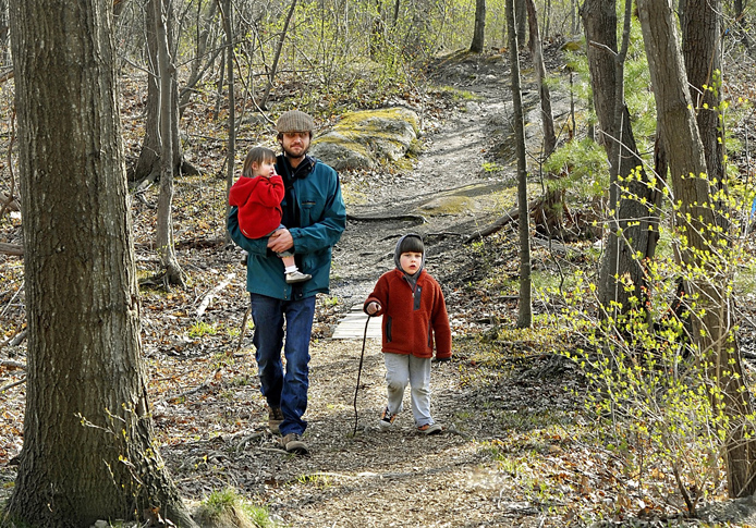 Back Cove area resident Tim Willoughby enjoys a spring walk in the Canco Woods with his daughter, Maeve, 2, and son Thomas, 4. Parenting Magazine describes Portland as a great place for "a laidback lifestyle that encourages healthy, active family living."