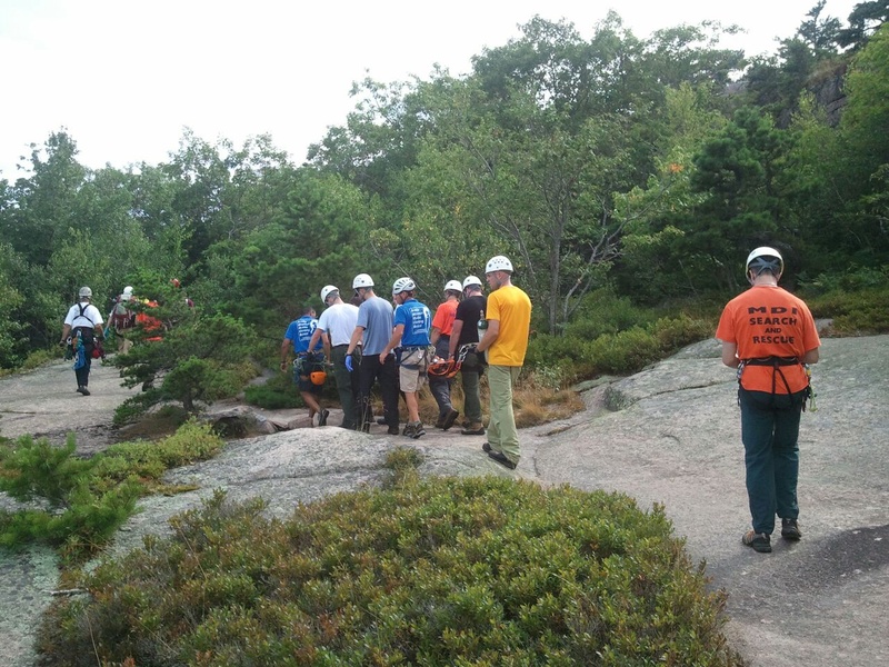 Personnel from the National Park Service, Mount Desert Island Search and Rescue, LifeFlight Of Maine and Acadia Mountain Guides assist in rescuing and giving medical care to Shirley Ladd, who was critically injured Saturday while hiking in Acadia National Park.