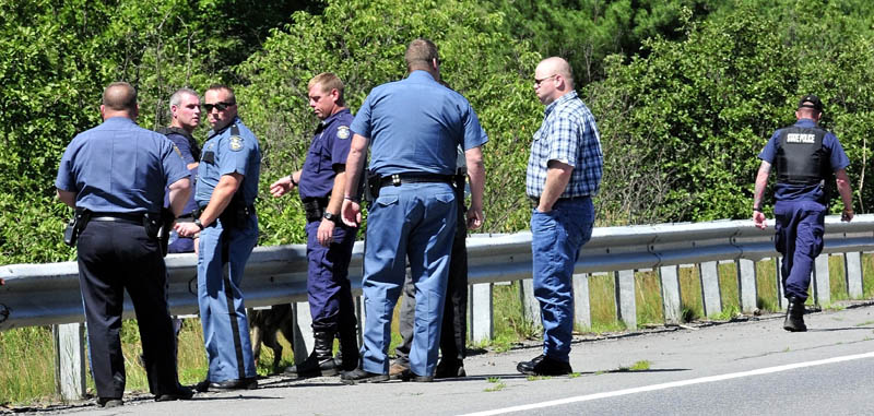Law enforcement officers from several agencies prepare to spread out along Route 150 in Skowhegan in an effort to capture escaped Somerset County Jail inmate Dylan Perkins on Monday.