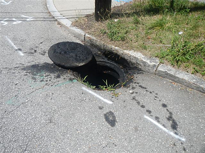 Waste oil residue surrounds the stormwater catch basin at Falmouth and St. John streets.