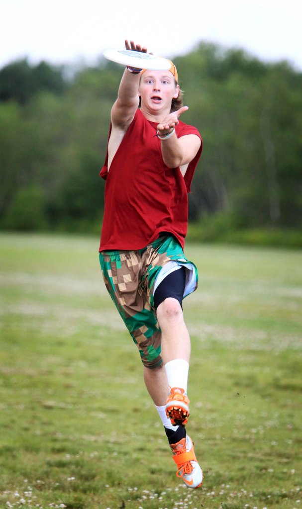 Hudson Carr of Falmouth makes a grab while warming up with Rising Tide before an ultimate Frisbee game at Wainwright Fields in South Portland.