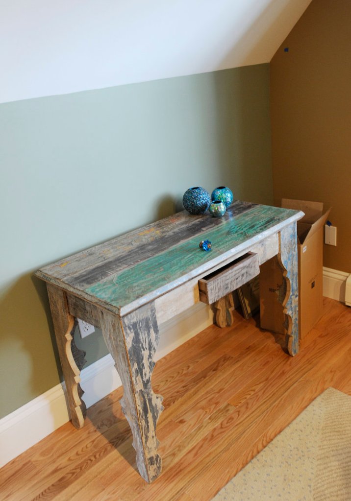 A table made in India of recycled wood sits in a family entertainment room decorated by Sue Bartlett.