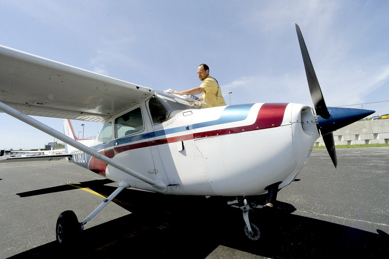 Jim Stenberg, above, and 16 other members of the Bald Eagle Flying Club, based at the Portland jetport, share use of a Cessna 172 to defray the costs of flying.