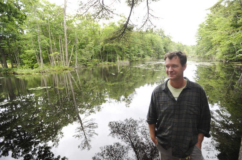Chris Franklin, executive director of the Cape Elizabeth Land Trust, near a pond on the land that the trust is trying to keep wild.