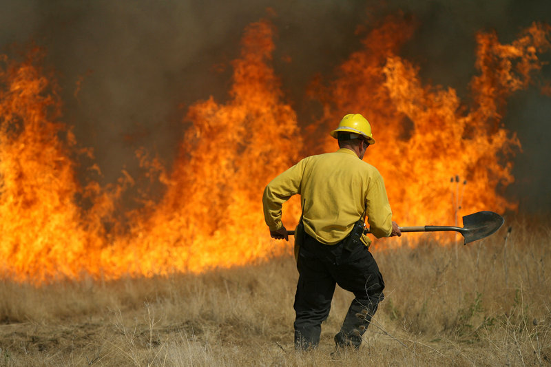 A member of the Rock Creek Rural Fire Protection District battles a blaze near the Hidden Lakes subdivision last week in Twin Falls, Idaho. Over the last 10 years, the wildfire season, which normally runs from June to September, has expanded to include May and October.