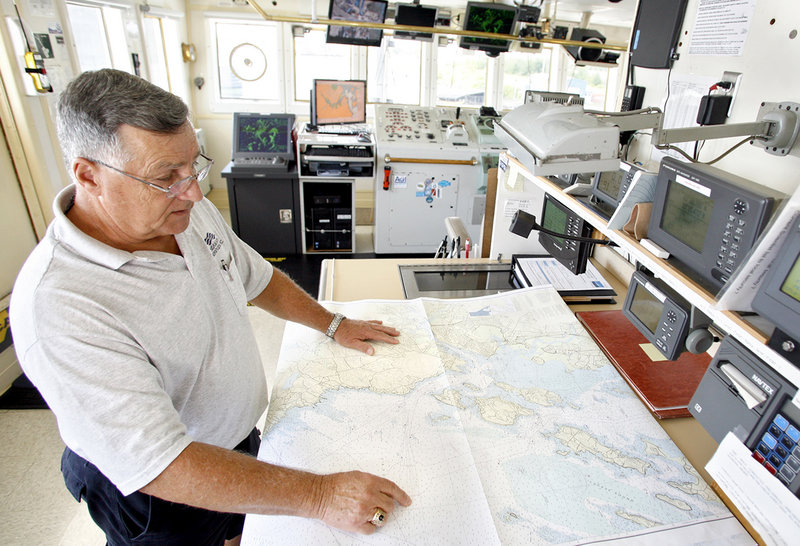 Second mate Phil Phlegar looks over a map of Casco Bay as the Bold’s crew prepares for about a week of mapping a swath of sea floor southeast of Cape Elizabeth.
