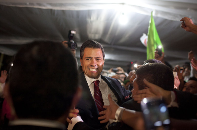 Enrique Pena Nieto, the apparent victor in Mexico’s presidential election, greets supporters at the headquarters of the Institutional Revolutionary Party in Mexico City early Monday.