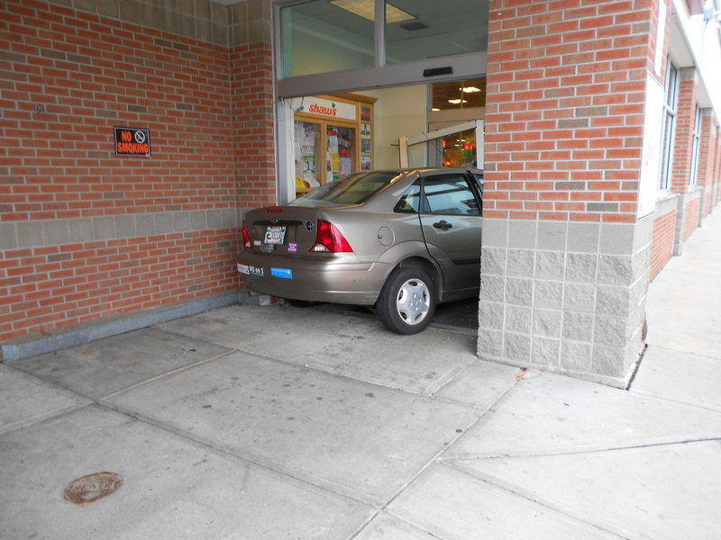 A 2003 Ford Focus sits in the entrance of the Shaw’s Supermarket on Scammon Street. “We were very lucky today” because no one was hurt, said police Sgt. Christopher Hardiman.