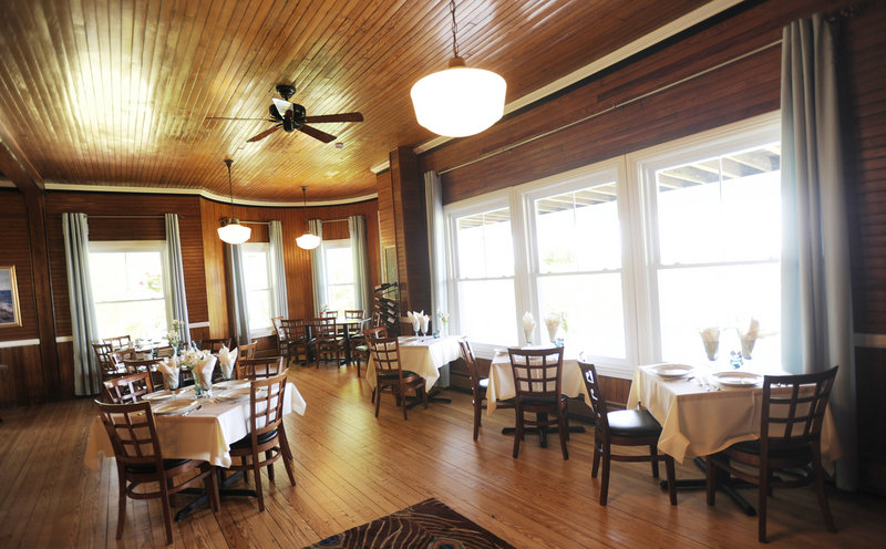 Inside Blue at the Grey Havens Inn, the dining room has dark beadboard walls and a rich wooden bar, ample open floor space, and large windows to take in the gorgeous views.