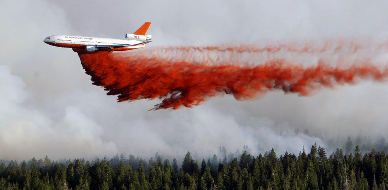A heavy tanker drops retardant as crews battle the Shingle Fire east of Cedar City, Utah, on Monday. The suspension of the Air Force’s C-130 flights Sunday left just 14 such planes in use.