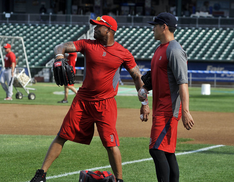 Carl Crawford, left, and Jacoby Ellsbury warm up in the outfield Wednesday as they prepare to play for the Portland Sea Dogs while on rehab assignments from the Red Sox.