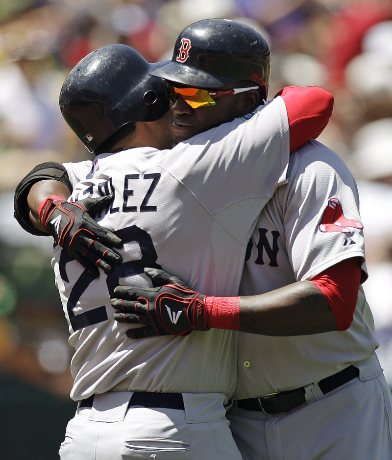 David Ortiz, right, is embraced by Adrian Gonzalez after hitting his 400th career home run Wednesday in Oakland, Calif.