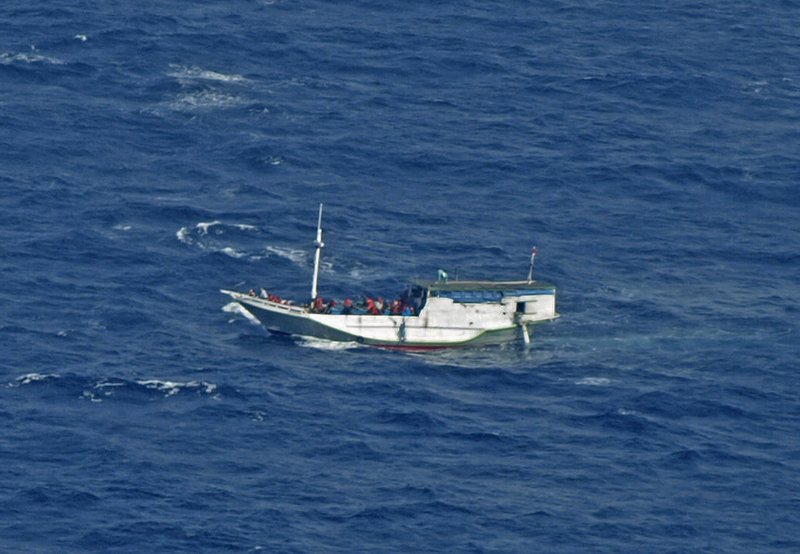 In a photo released by the Indonesian National Search and Rescue Agency, a boat believed to have 162 asylum seekers on board floats on the waters off Christmas Island, Australia, Wednesday.