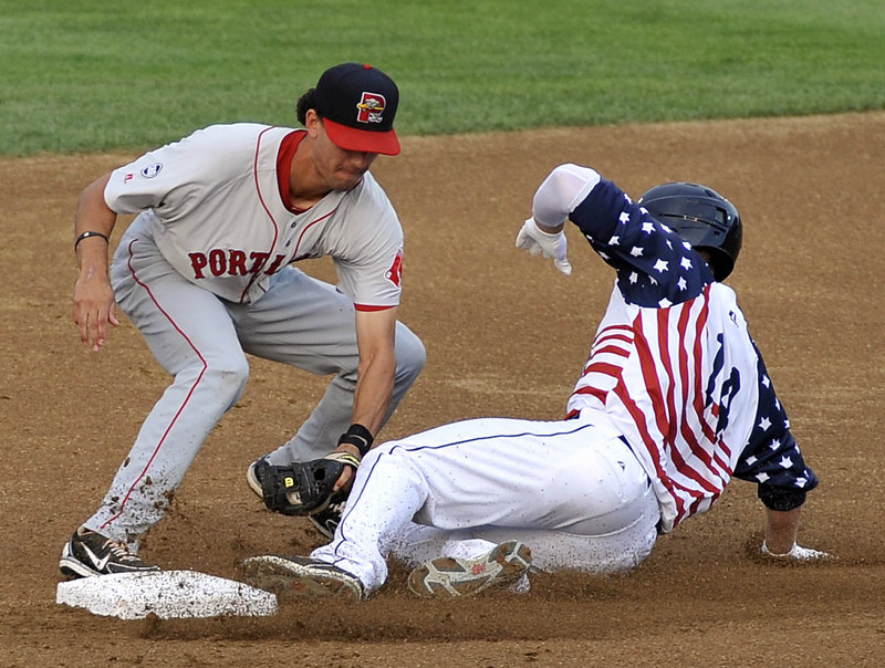 Mark Sobolewski of the New Hampshire Fisher Cats is tagged out by shortstop Derrik Gibson of Portland in the first inning of the Sea Dogs’ 11-10 loss in 11 innings Wednesday.