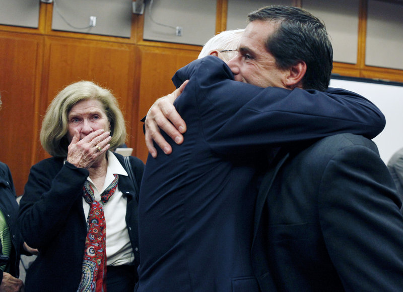Will Lynch, right, hugs his father, John Lynch, as his mother, Peggy Lynch, watches after he was found not guilty of two felonies Thursday. He was accused of beating an aging priest who Lynch says molested him and his younger brother more than 35 years ago.