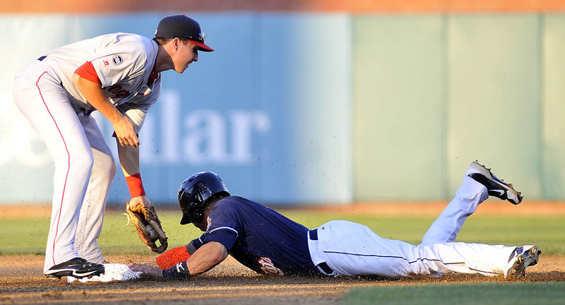 Brian Van Kirk of the New Hampshire Fisher Cats slides into second with a stolen base Thursday night as Nick Natoli of the Portland Sea Dogs applies the late tag.