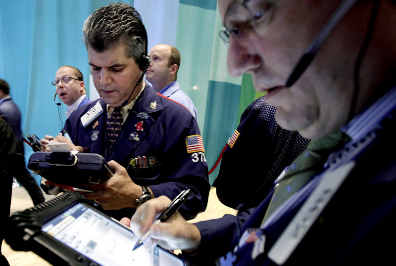 Traders work on the floor of the New York Stock Exchange. Stocks dropped Friday after the government reported that only 80,000 jobs were created in June.
