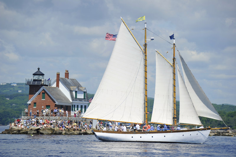 The schooner Olad sails past the Rockland Breakwater Lighthouse on Friday. This year for the first time the event was planned more than a few days ahead.