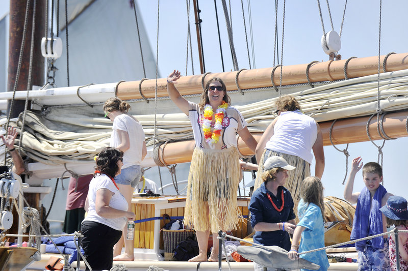 Brenda Thomas, owner and captain of the schooner Isaac H. Evans, waves to other boaters before the sailing started. Her crew included 21 paying guests on a four-day cruise.