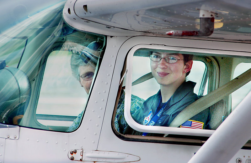 Olivia Fowler, right, finishes her test ride to get her pilot’s license on her 17th birthday Friday as a present from her family. Next to her in the cockpit is Mary Build, an examiner from the Federal Aviation Administration.