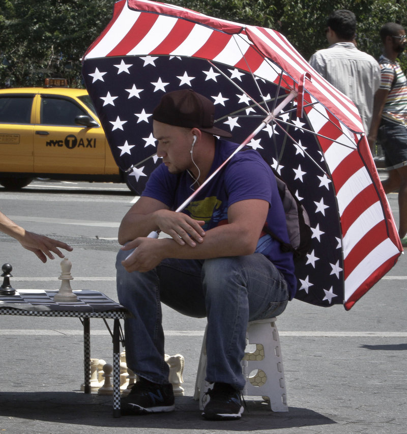 Luis Saavevra plays chess in New York’s Union Square, with highs in the 90s.