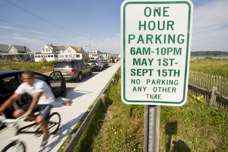 Parking on Bayview Avenue at Higgins Beach in Scarborough is allowed for free for one hour in designated spaces. Some residents want the town to require people to buy beach passes to park there.