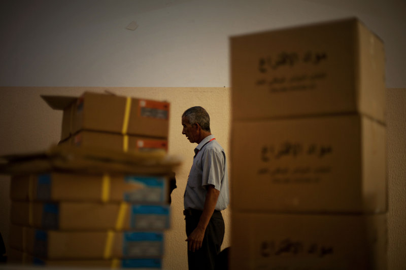 An electoral official prepares a polling station for today’s elections in Tripoli, Libya, on Friday. The Libyan National Assembly vote will be the first free elections since 1969.