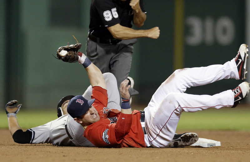 Nick Punto of the Boston Red Sox holds onto the ball Friday night after tagging out Eric Chavez of the New York Yankees, who was attempting to stretch a single to a double in the sixth inning at Fenway Park. The Yankees opened the four-game series with a 10-8 victory.