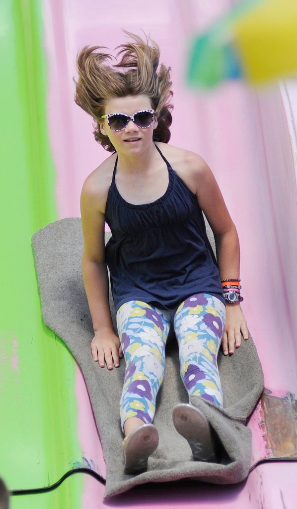 Katy Tucker, 10, of Bath rides down the super slide in the midway.
