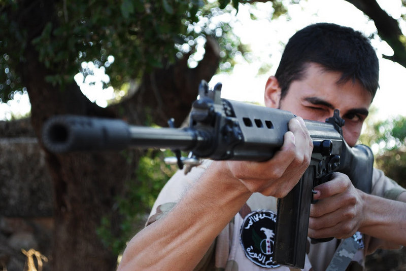 This citizen journalism image, taken July 4, purports to show a Free Syrian Army soldier aiming his weapon in the northern town of Sarmada, in Idlib province, Syria. The French foreign minister said Friday that the Syrian regime has killed at least 16,000 people.