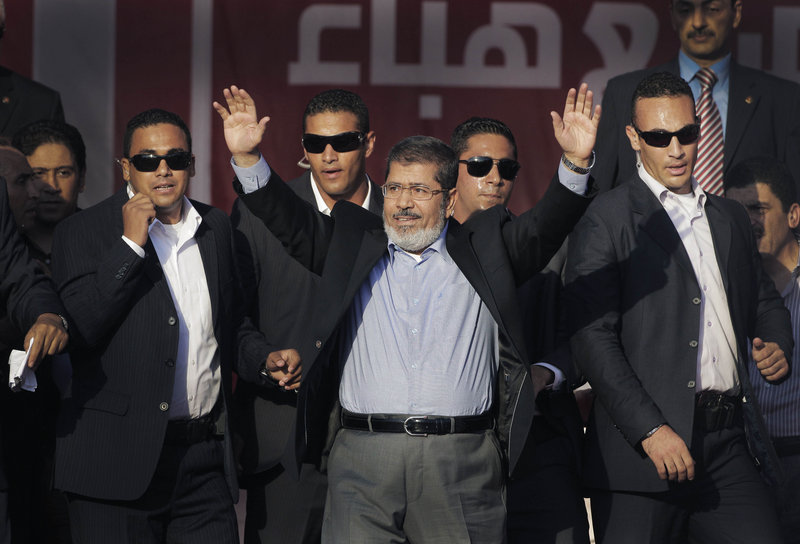 Egypt's new President-elect Mohammed Morsi waves to supporters at Tahrir Square, the focal point of Egyptian uprising, last month in Cairo, Egypt.